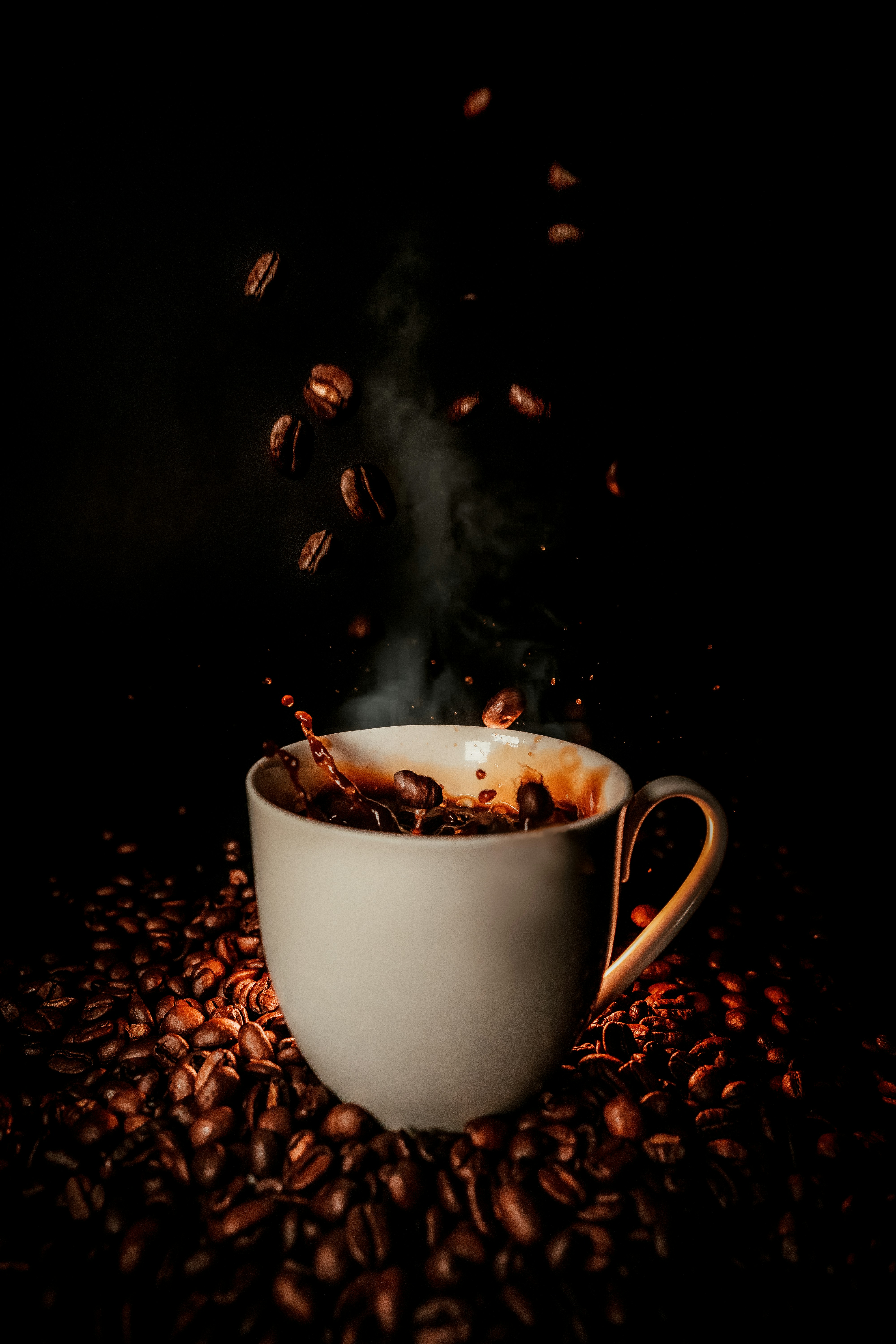 Coffee beans falling into a cup, representing the magic of coffee